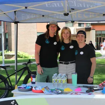 3 students pose at Recreation Tent at Tour de Rec