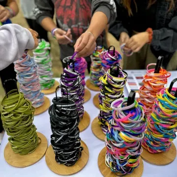 A bunch of colorful silicone bracelets representing a diverse array of queer identities.